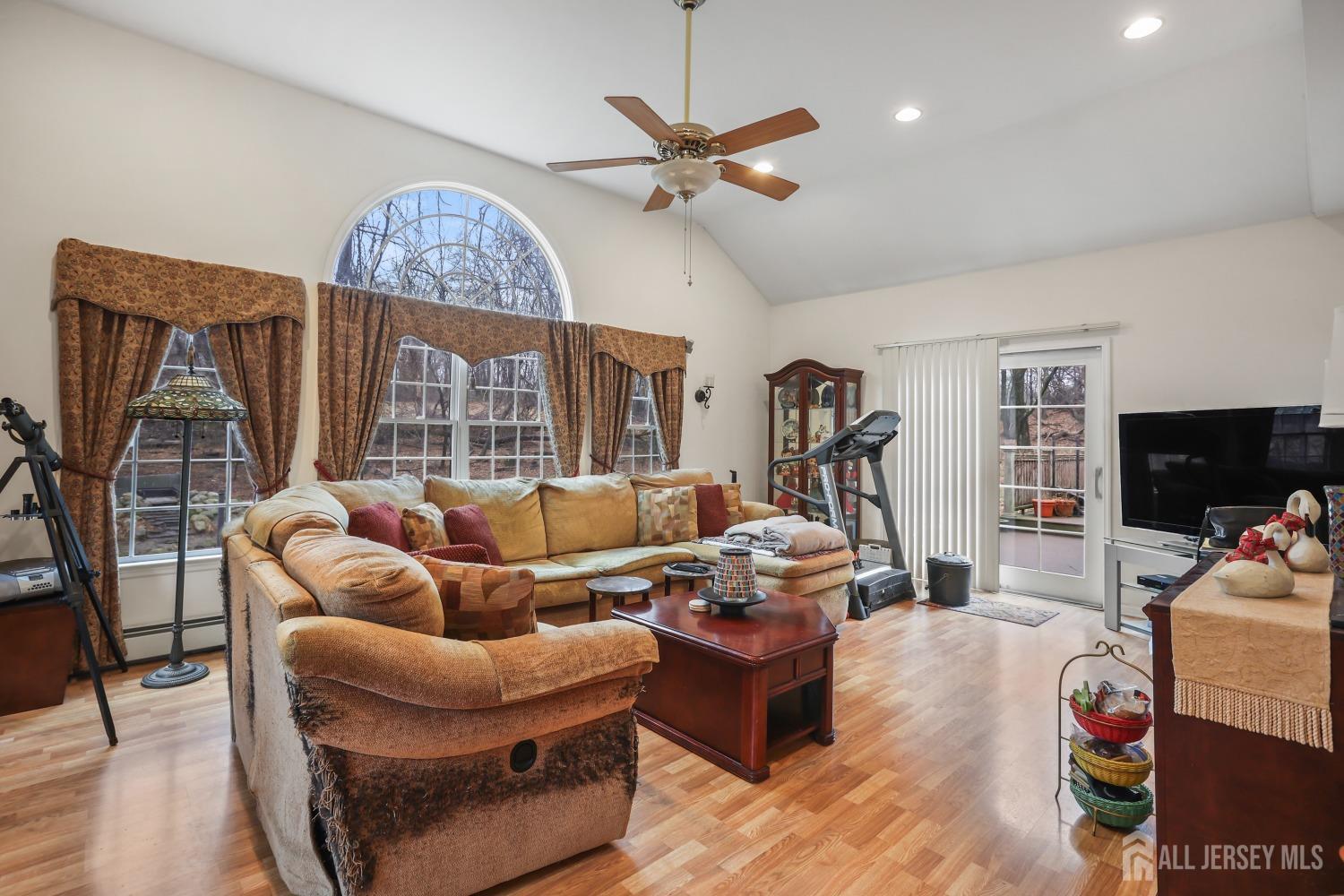 75 Baird Road Millstone Township, NJ 08535 - Photo 12 of 30 a living room with furniture a flat screen tv and a window