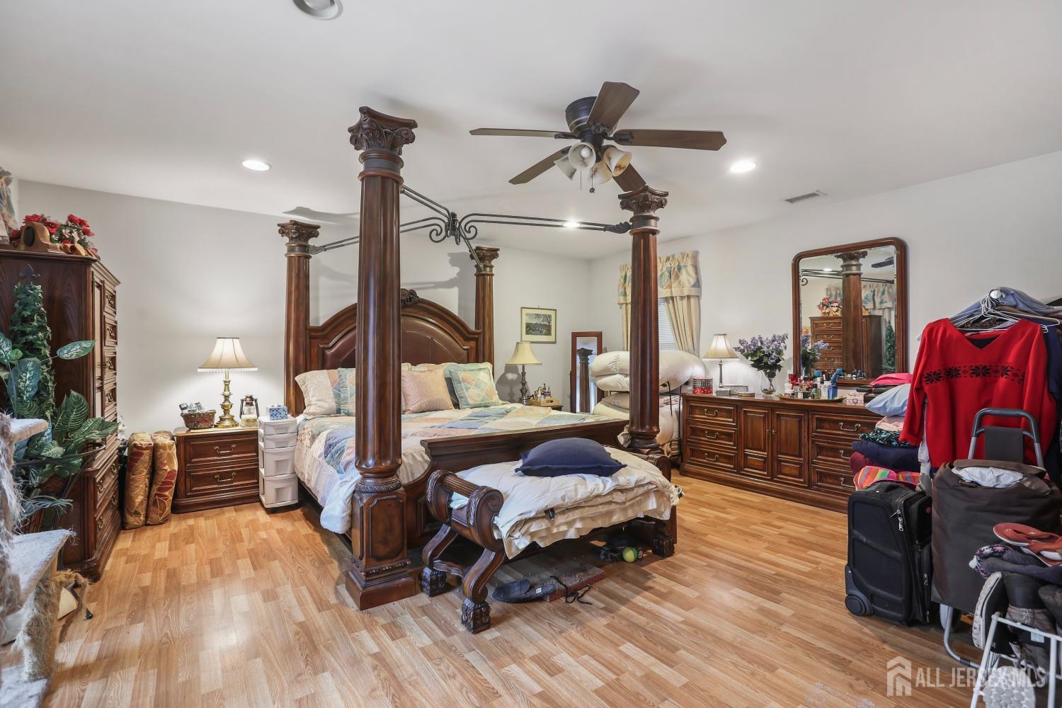 75 Baird Road Millstone Township, NJ 08535 - Photo 14 of 30 a bedroom with furniture and a wooden floor
