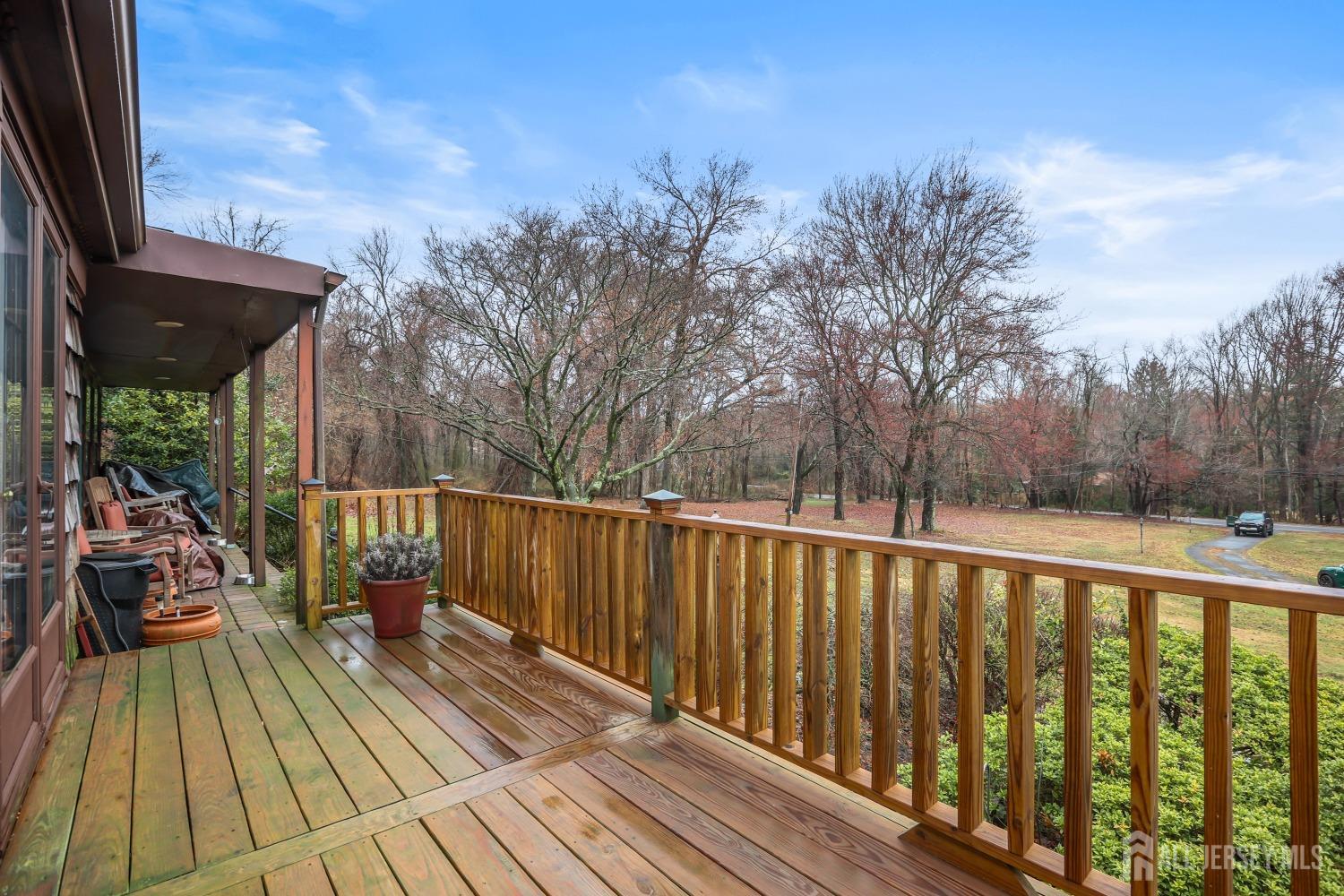75 Baird Road Millstone Township, NJ 08535 - Photo 27 of 30 a view of balcony with wooden floor and outdoor seating