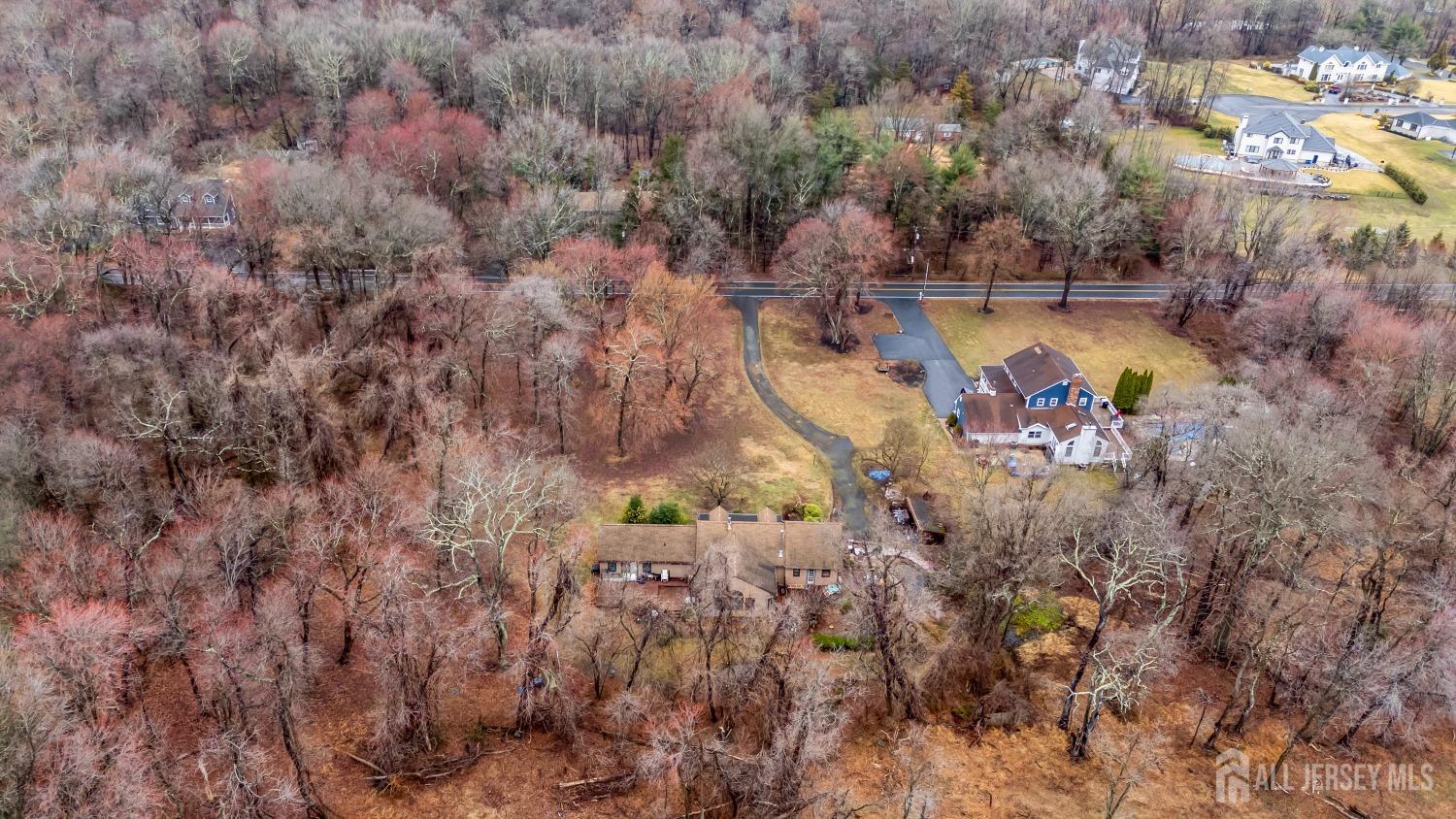 75 Baird Road Millstone Township, NJ 08535 - Photo 29 of 30 a aerial view of a house with a yard and lake view