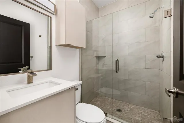 a bathroom with a sink toilet and shower