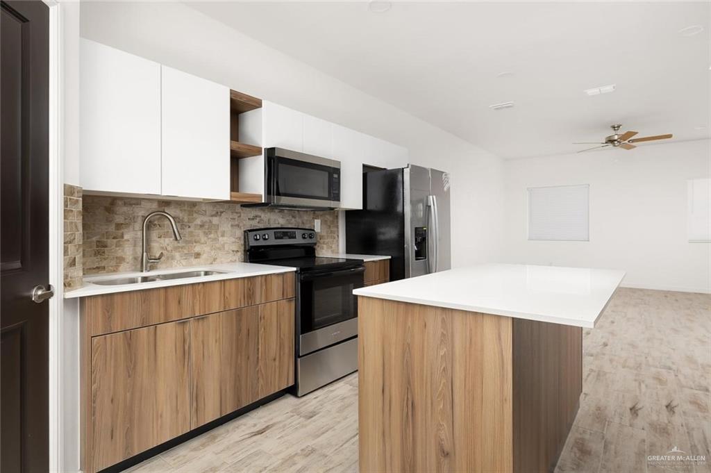 605 Jasper Street, Unit 2 Edinburg, TX 78541 - Photo 3 of 13 a kitchen with stainless steel appliances a microwave sink refrigerator and cabinets