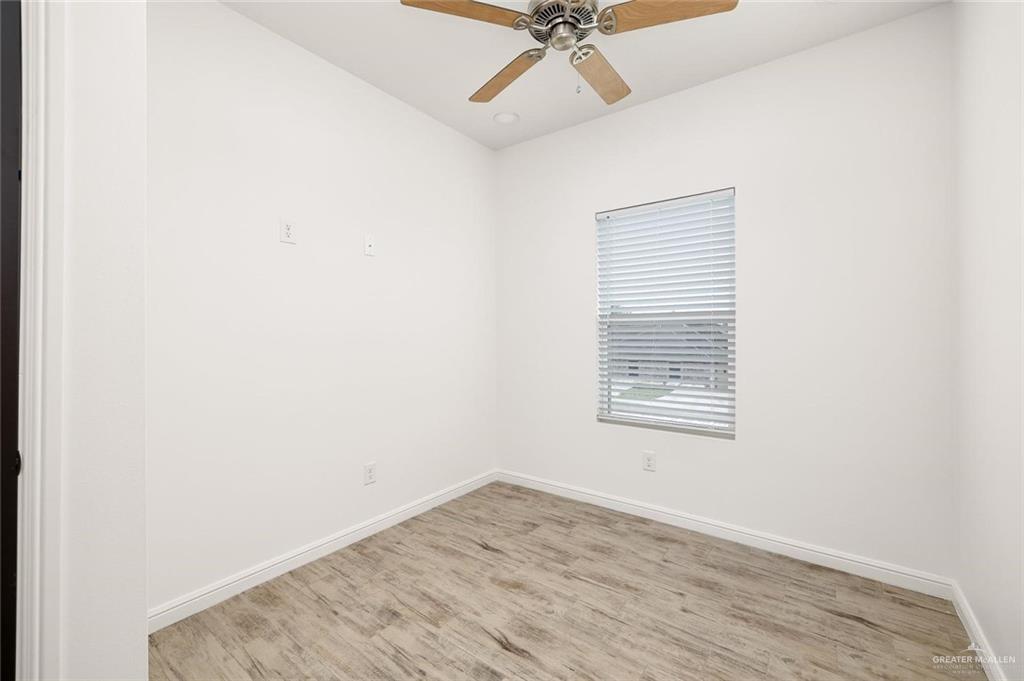 605 Jasper Street, Unit 2 Edinburg, TX 78541 - Photo 9 of 13 an empty room with a window and a fan