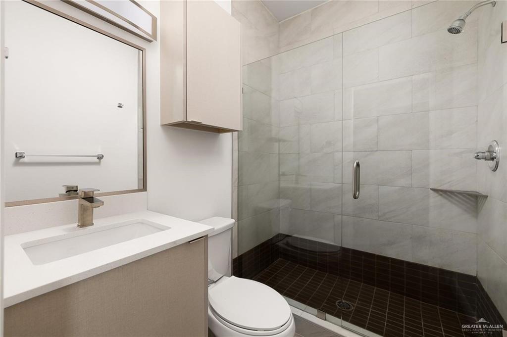 605 Jasper Street, Unit 2 Edinburg, TX 78541 - Photo 10 of 13 a bathroom with a sink a toilet and shower