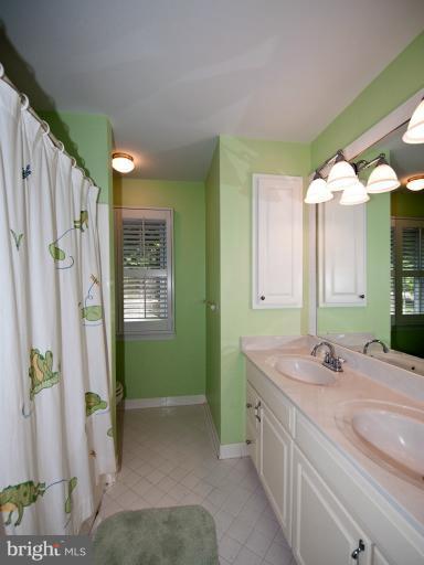 8717 Postoak Road Potomac, MD 20854 - Photo 17 of 22 Hall Bath w/Tub and Double Sinks