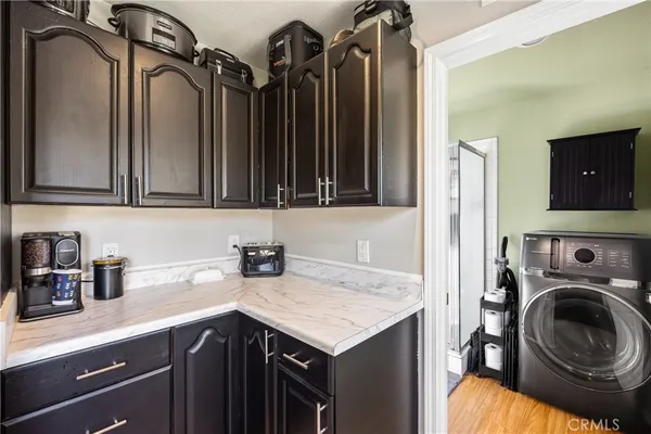 a kitchen with a sink a stove and cabinets