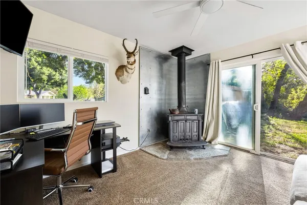 a view of a workspace with furniture and a window