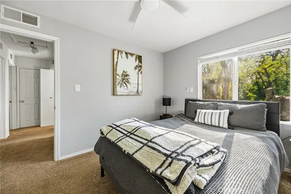 a bedroom with a bed and a painting on the wall