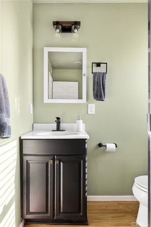 a bathroom with a sink a toilet and mirror