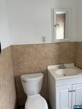 a bathroom with a toilet sink and mirror