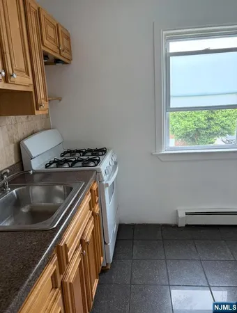 a kitchen with a sink a stove and a microwave oven