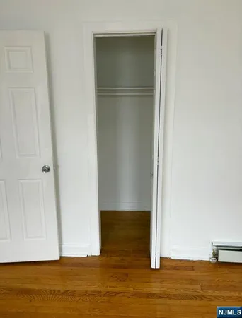 a view of room with wooden floor