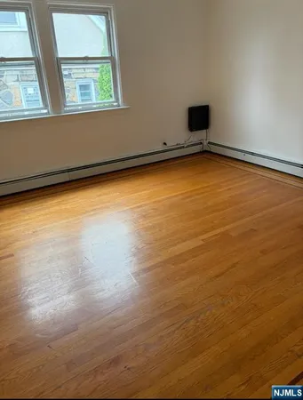 a view of a room with wooden floor and a window