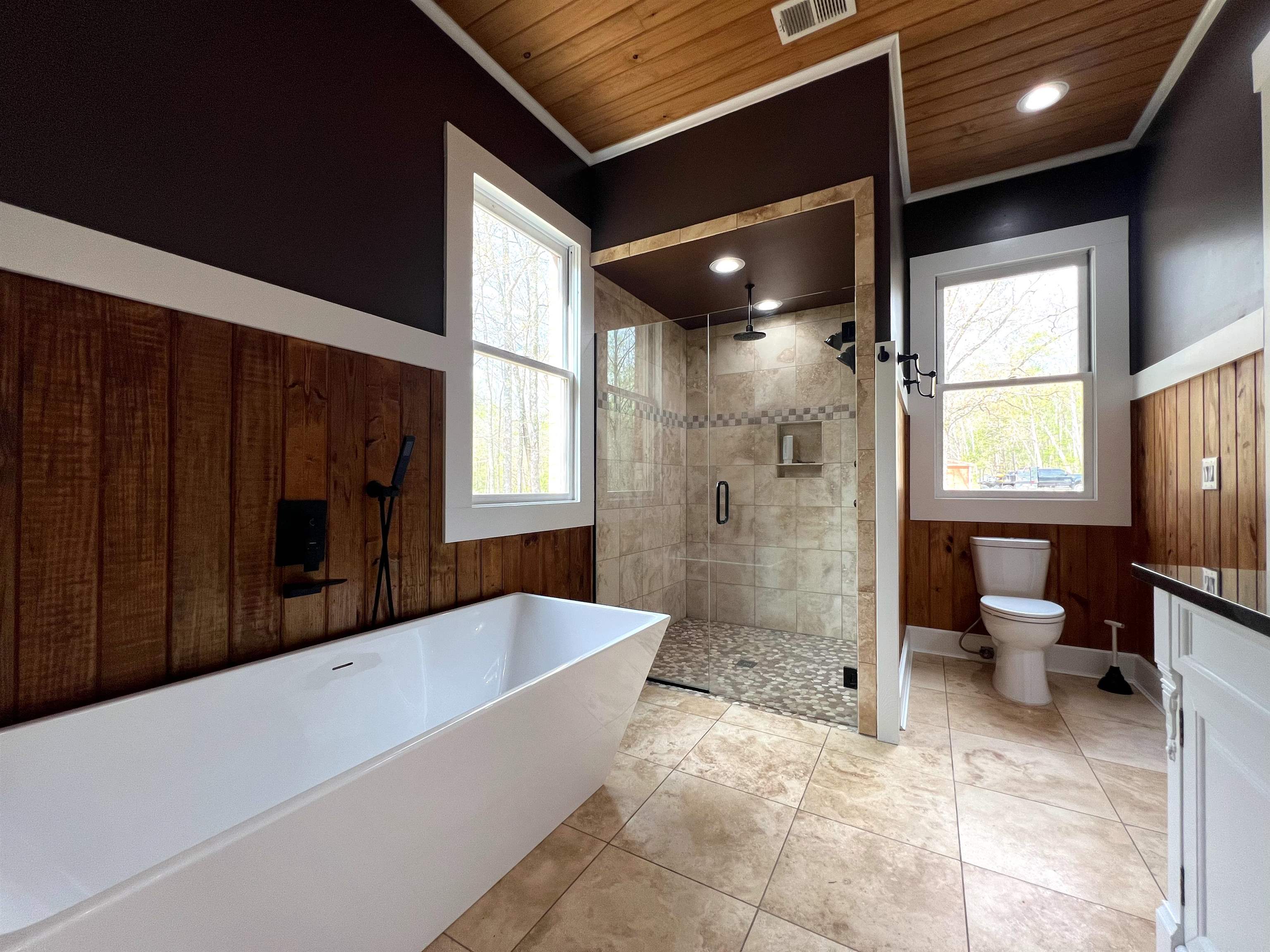 9490 Highway 196 Collierville, TN 38017 - Photo 18 of 40 Full bath with wooden walls, a shower stall, a soaking tub, wainscoting, and recessed lighting