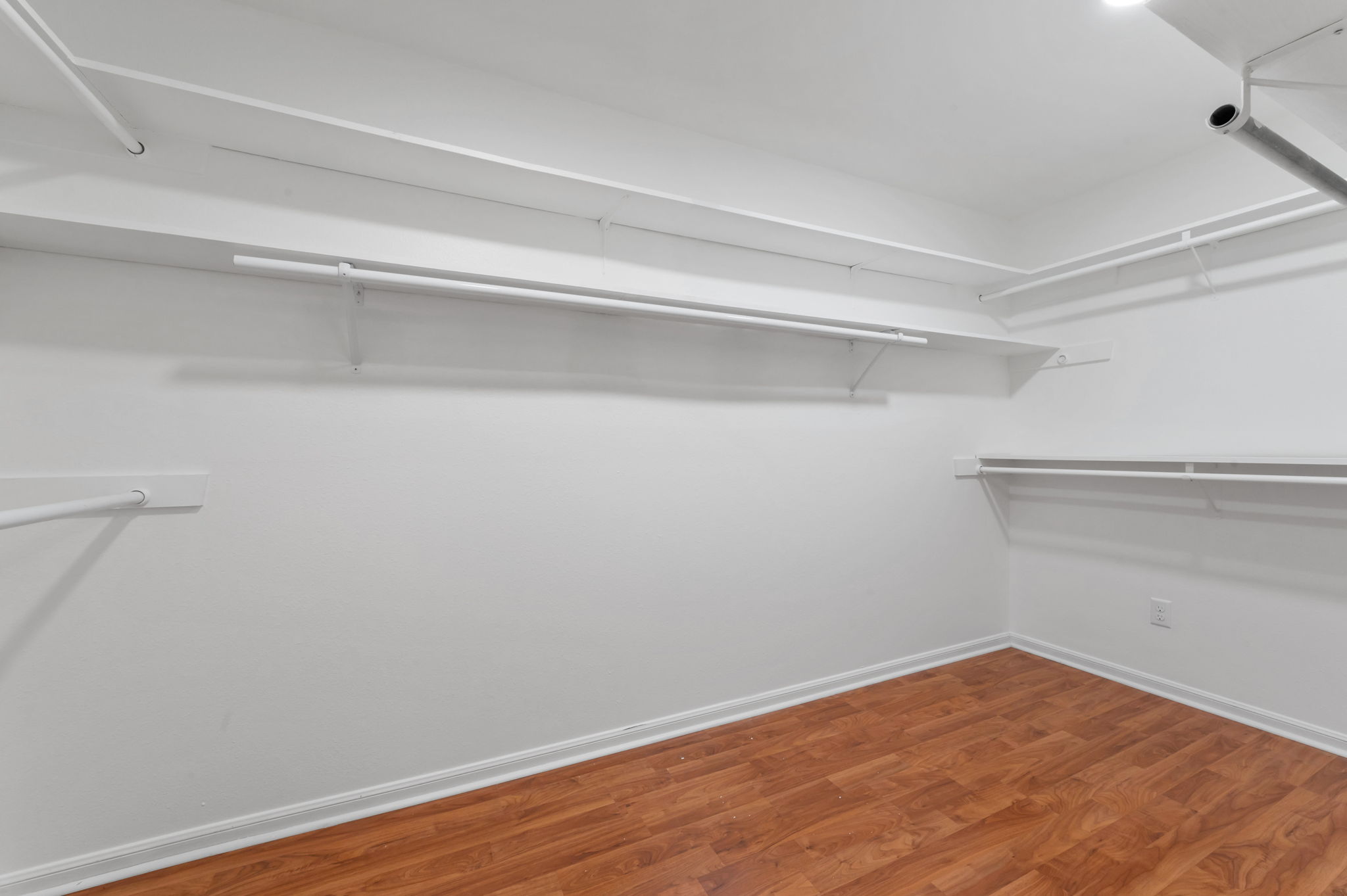 11127 Pinehurst Drive, Unit E Austin, TX 78747 - Photo 16 of 31 a view of a room with wooden floor