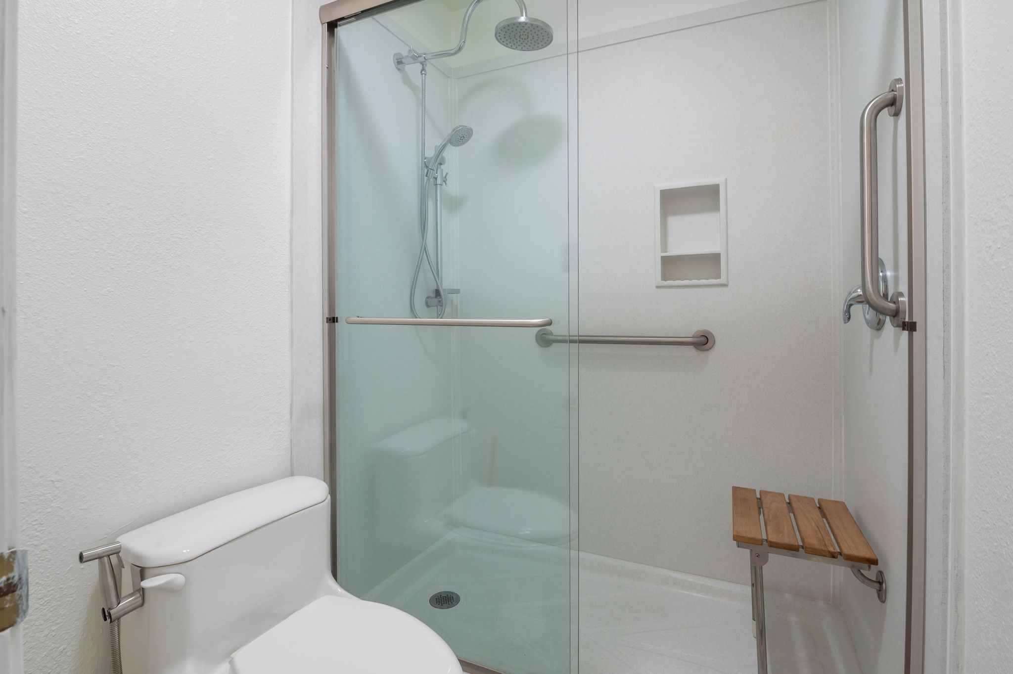 11127 Pinehurst Drive, Unit E Austin, TX 78747 - Photo 20 of 31 a white toilet sitting next to a shower