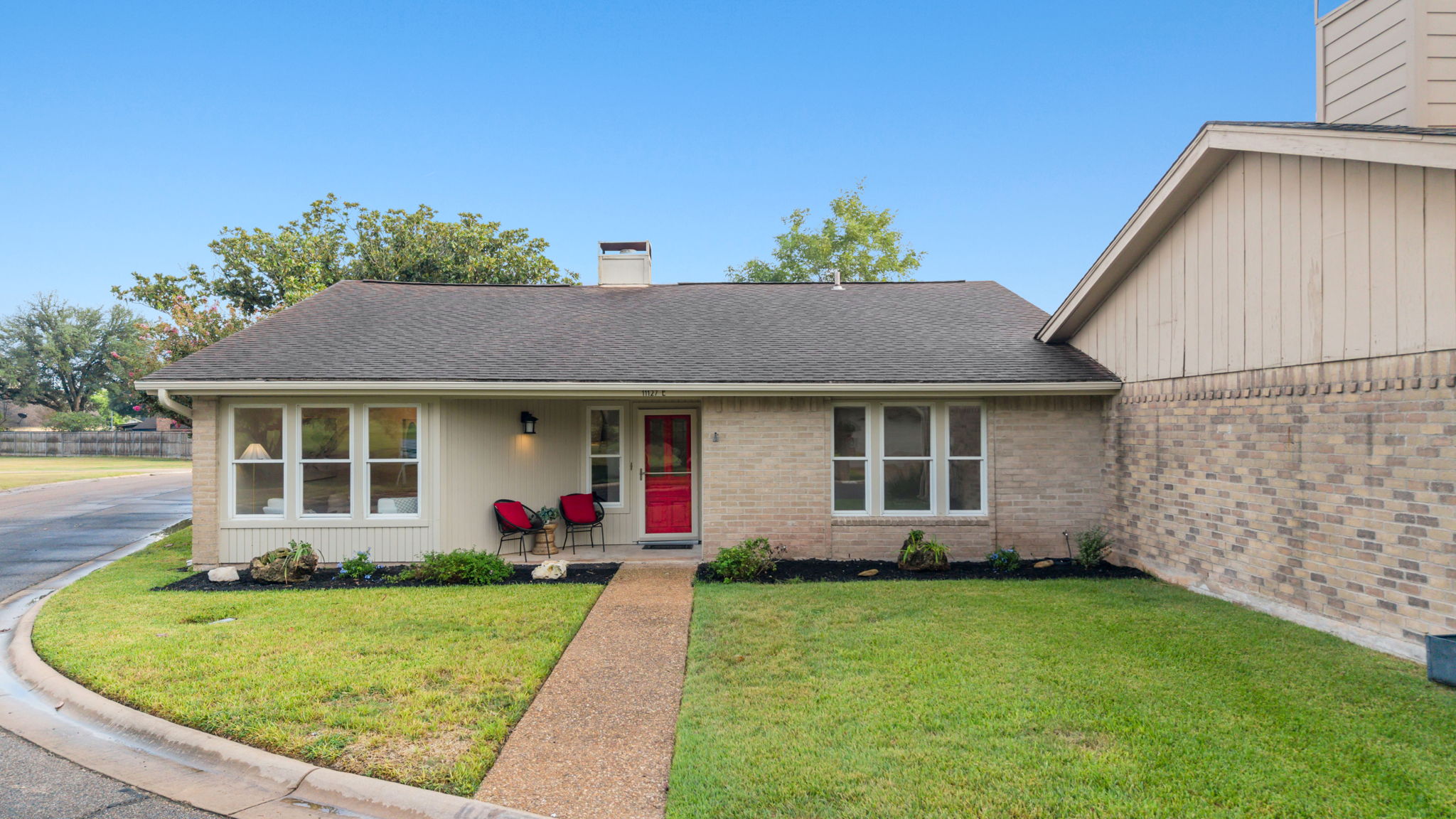 11127 Pinehurst Drive, Unit E Austin, TX 78747 - Photo 26 of 31 a front view of a house with garden