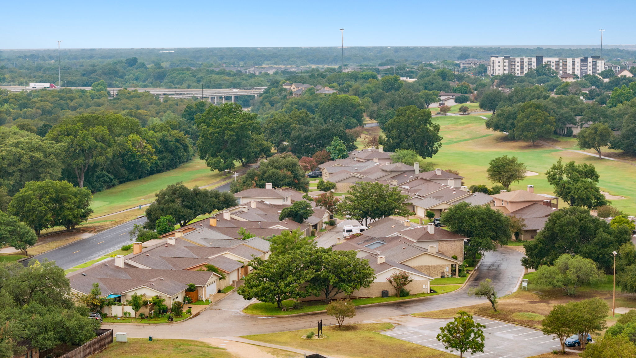11127 Pinehurst Drive, Unit E Austin, TX 78747 - Photo 31 of 31 an aerial view of residential houses with outdoor space and lake view