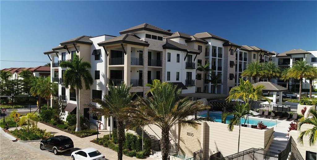 1130 3rd Avenue South, Unit 105 Naples, FL 34102 - Photo 3 of 9 a view of a building with potted plants