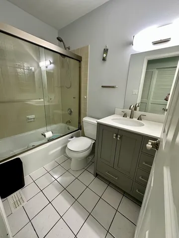 a spacious bathroom with a double vanity sink mirror and toilet