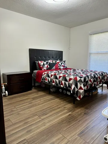 a bedroom with a bed closet and window