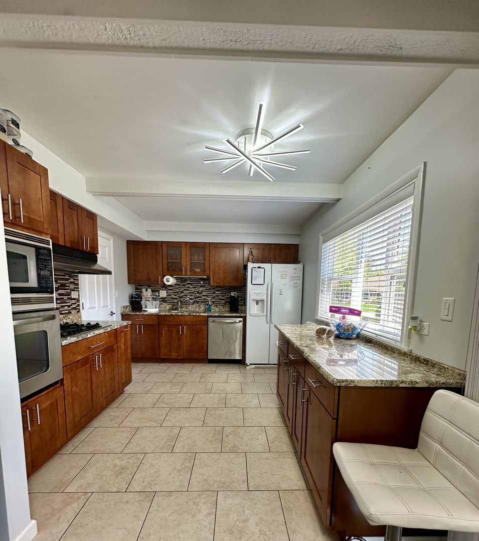 440 Red Bridge Road Lake Zurich, IL 60047 - Photo 8 of 33 a kitchen with stainless steel appliances granite countertop a stove a sink dishwasher a dining table and chairs with wooden floor