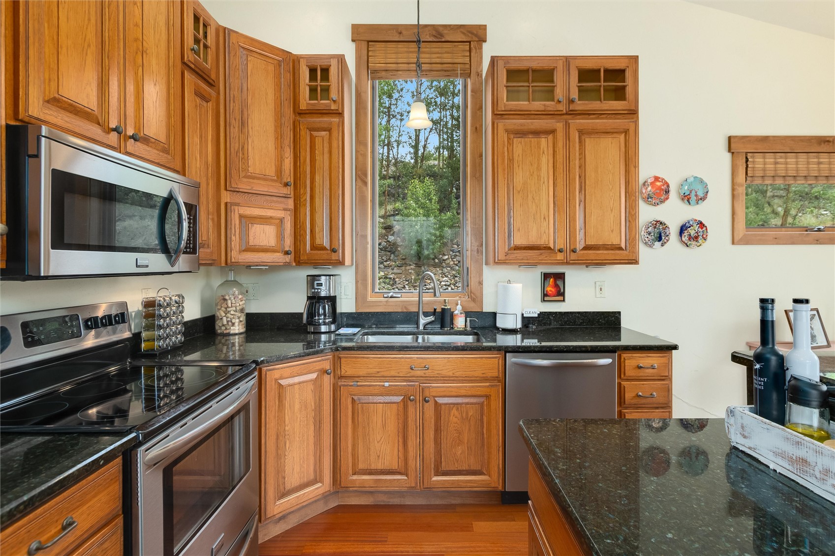 592 Ponderosa Road Fairplay, CO 80440 - Photo 20 of 45 a kitchen with stainless steel appliances granite countertop a stove a sink dishwasher and microwave oven with cabinets
