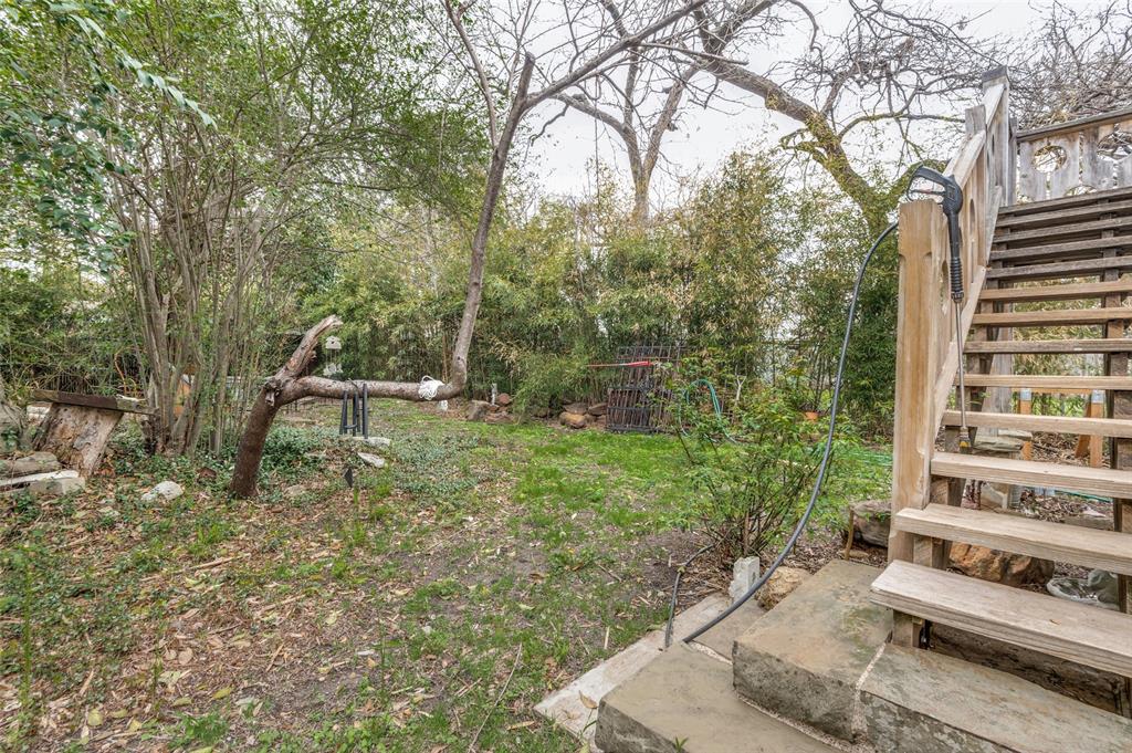 5615 Victor Street Dallas, TX 75214 - Photo 11 of 13 a view of a bench in a backyard