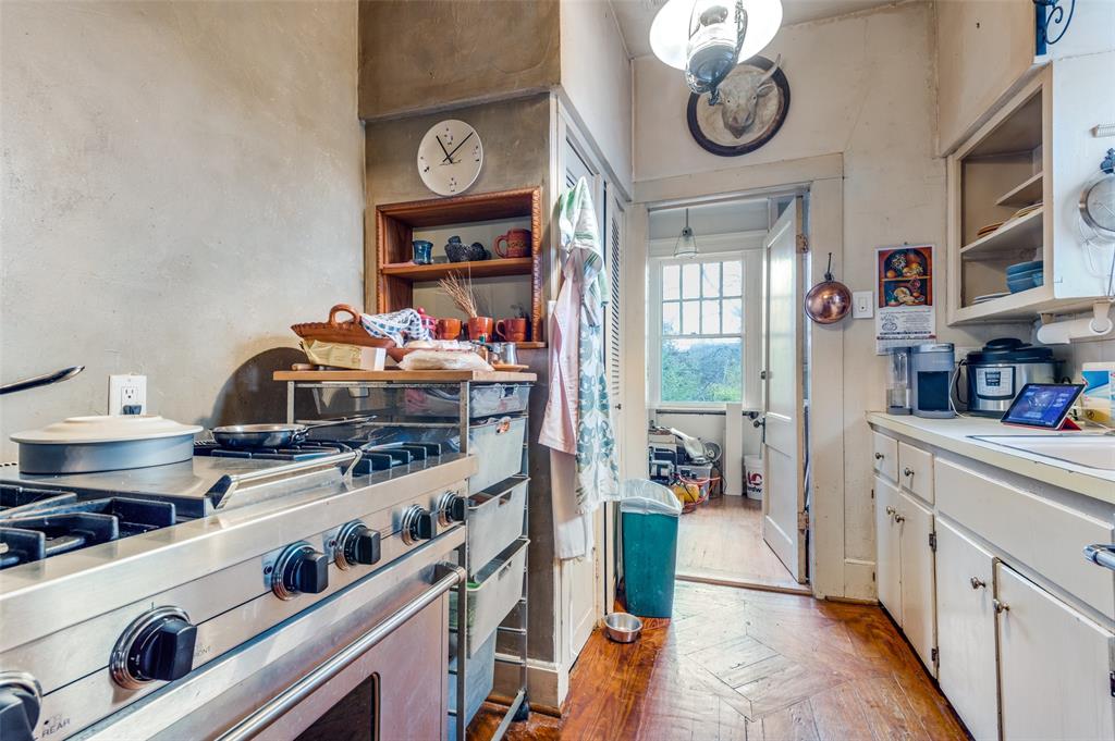 5615 Victor Street Dallas, TX 75214 - Photo 5 of 13 a kitchen with stainless steel appliances a stove and cabinets