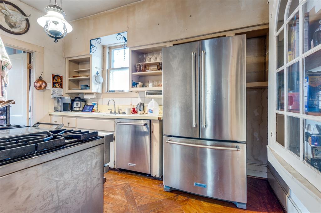 5615 Victor Street Dallas, TX 75214 - Photo 6 of 13 a kitchen with stainless steel appliances granite countertop a refrigerator and a stove top oven