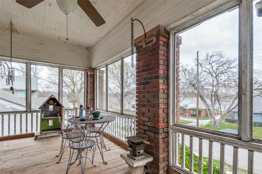 5615 Victor Street Dallas, TX 75214 - Photo 10 of 13 a view of a porch with furniture and wooden floor