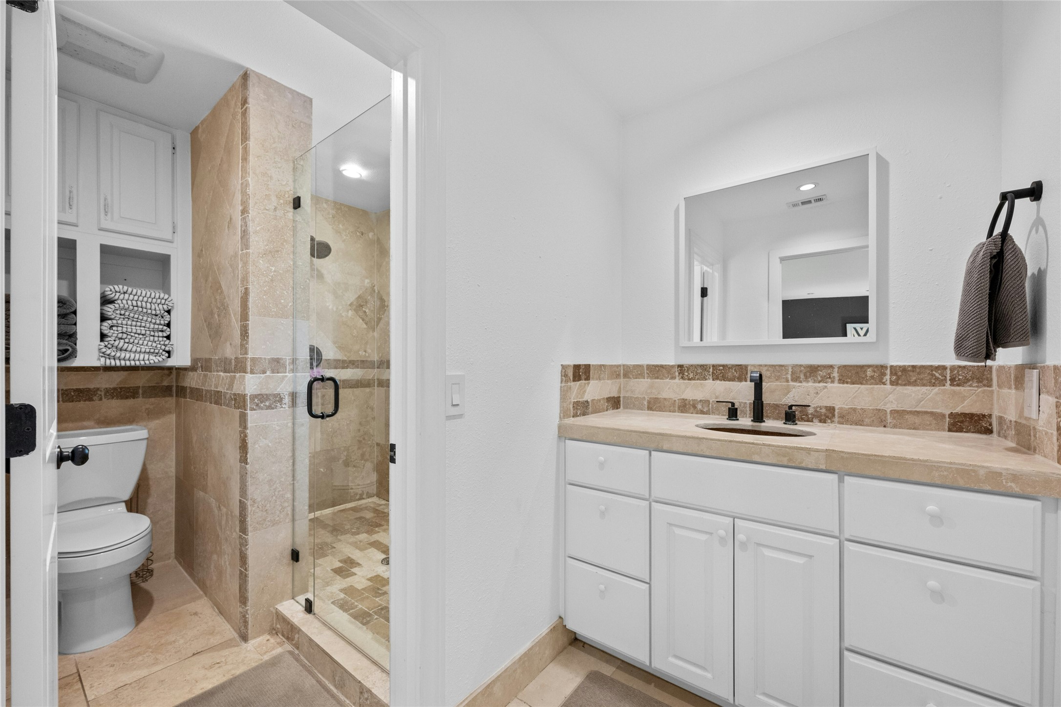 1603 Twilight Ridge Drive Austin, TX 78746 - Photo 17 of 34 a bathroom with a sink a toilet and shower