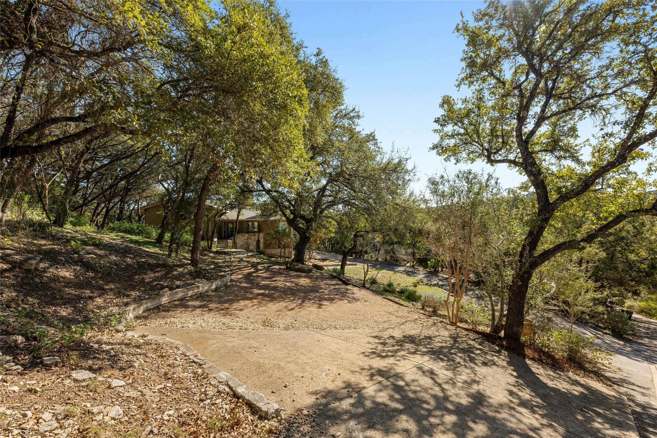 1603 Twilight Ridge Drive Austin, TX 78746 - Photo 2 of 34 a view of a yard with trees