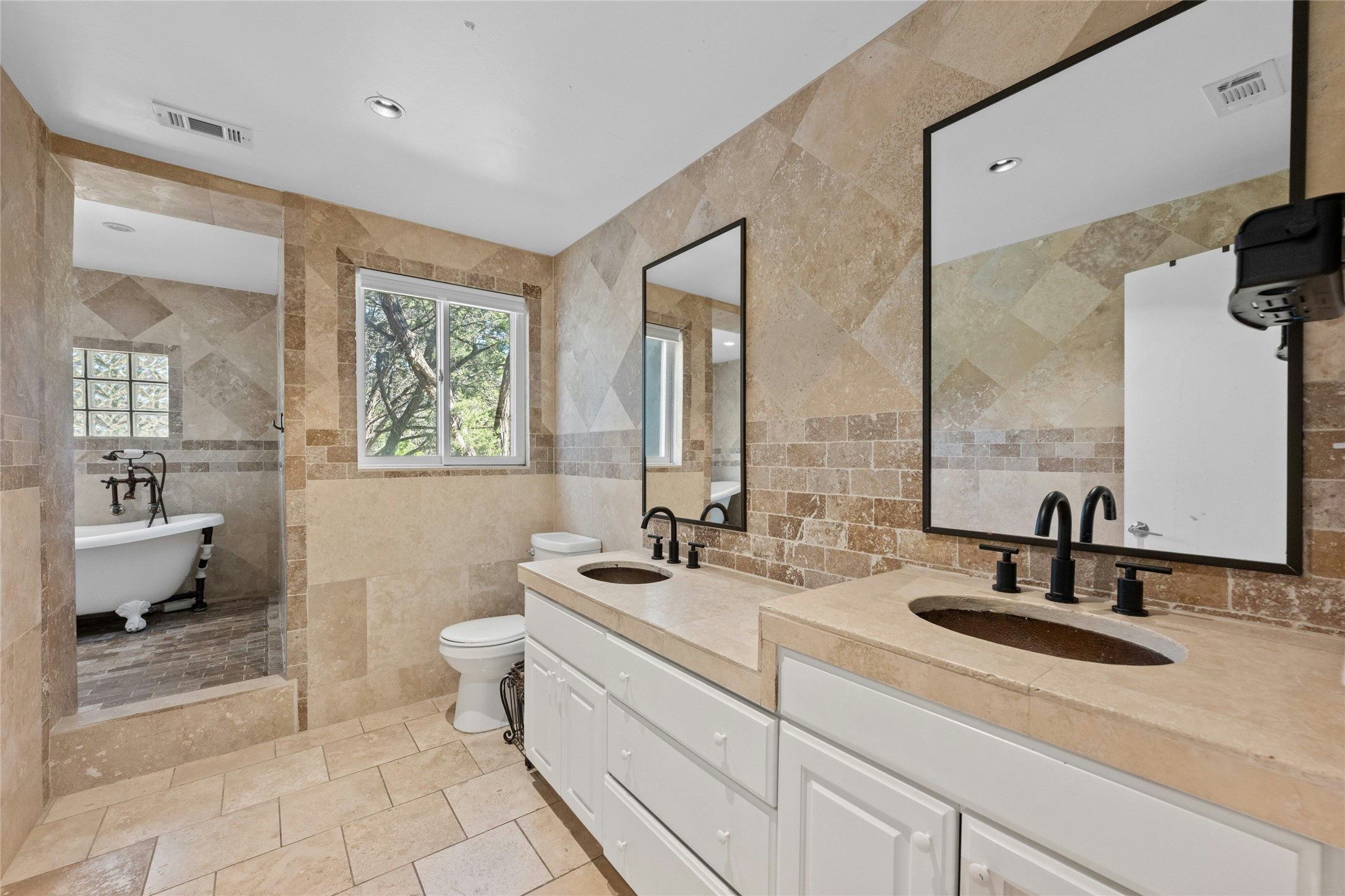 1603 Twilight Ridge Drive Austin, TX 78746 - Photo 21 of 34 a bathroom with double vanity sinks a mirror and a shower