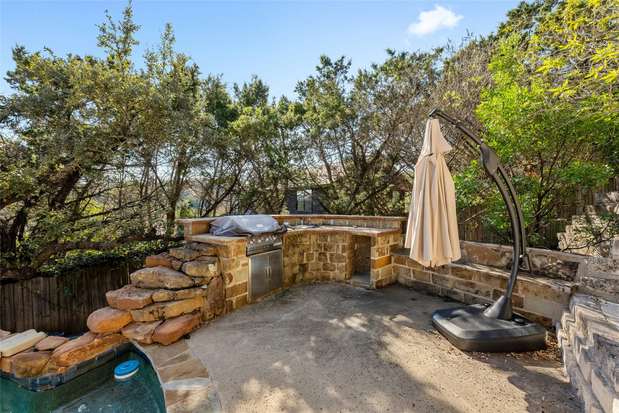 1603 Twilight Ridge Drive Austin, TX 78746 - Photo 33 of 34 a view of a patio with chairs and plants
