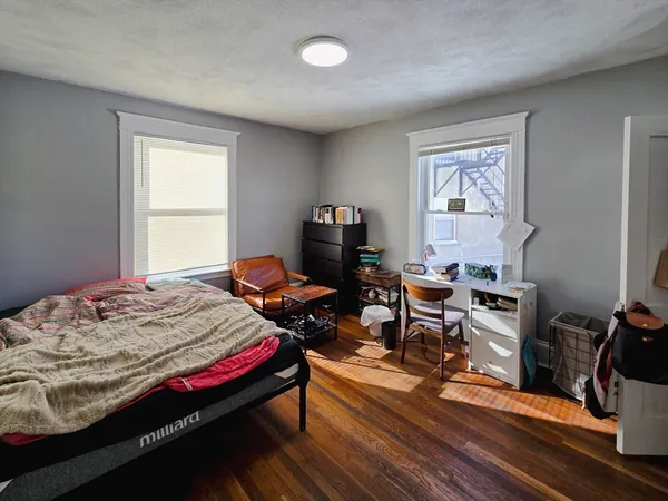 a bedroom with bed and a window