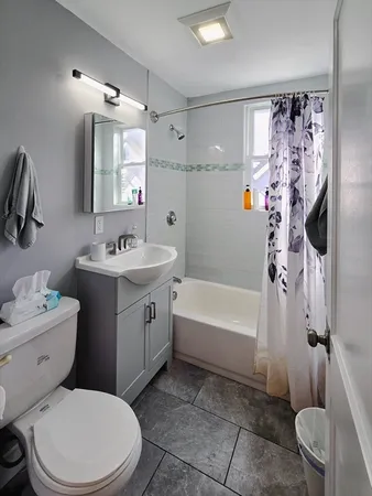 a bathroom with a sink toilet vanity and shower