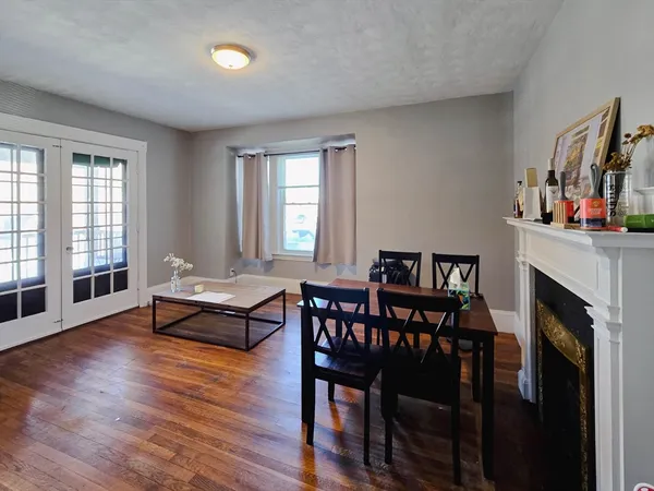 a dining room with furniture and wooden floor