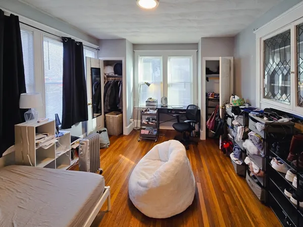 a living room filled with furniture and a mirror