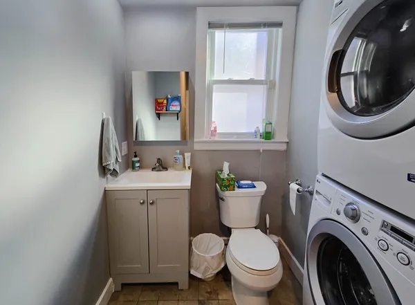 a bathroom with a sink mirror and toilet
