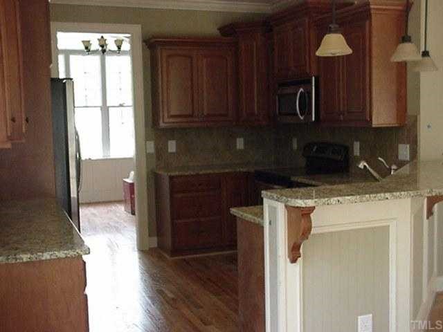 39 High Ridge Court Willow Spring, NC 27592 - Photo 3 of 8 a kitchen with a sink a microwave a refrigerator and cabinets
