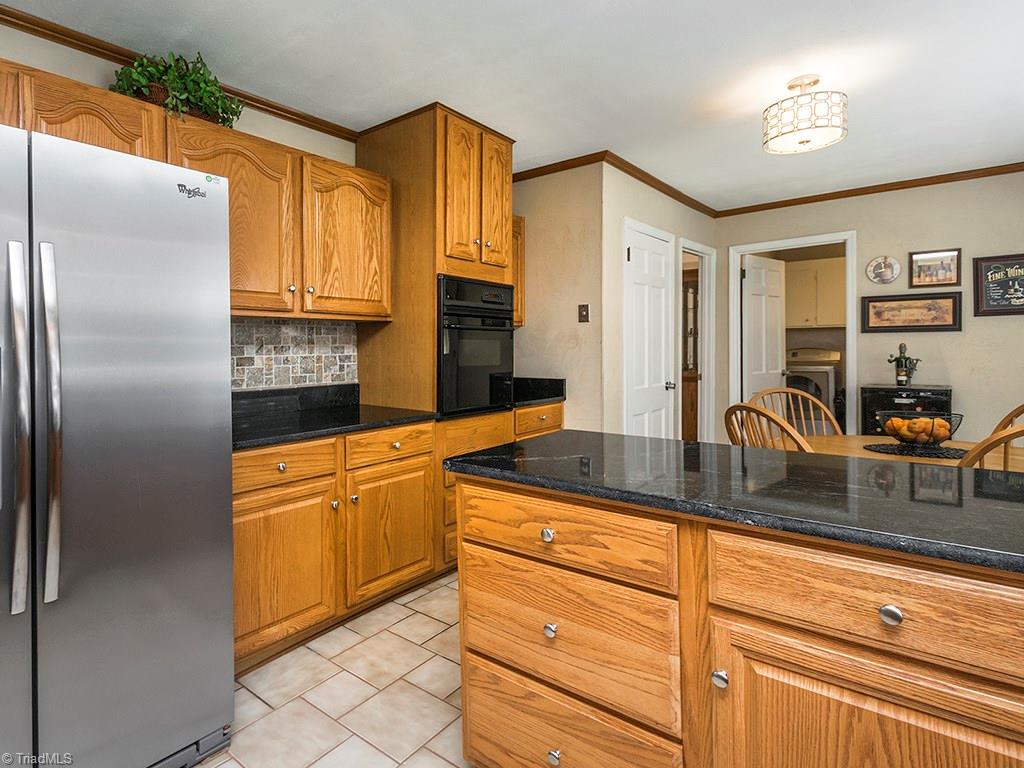 4521 Tower Road Greensboro, NC 27410 - Photo 11 of 28 Kitchen side area featuring serving counter and built-in oven