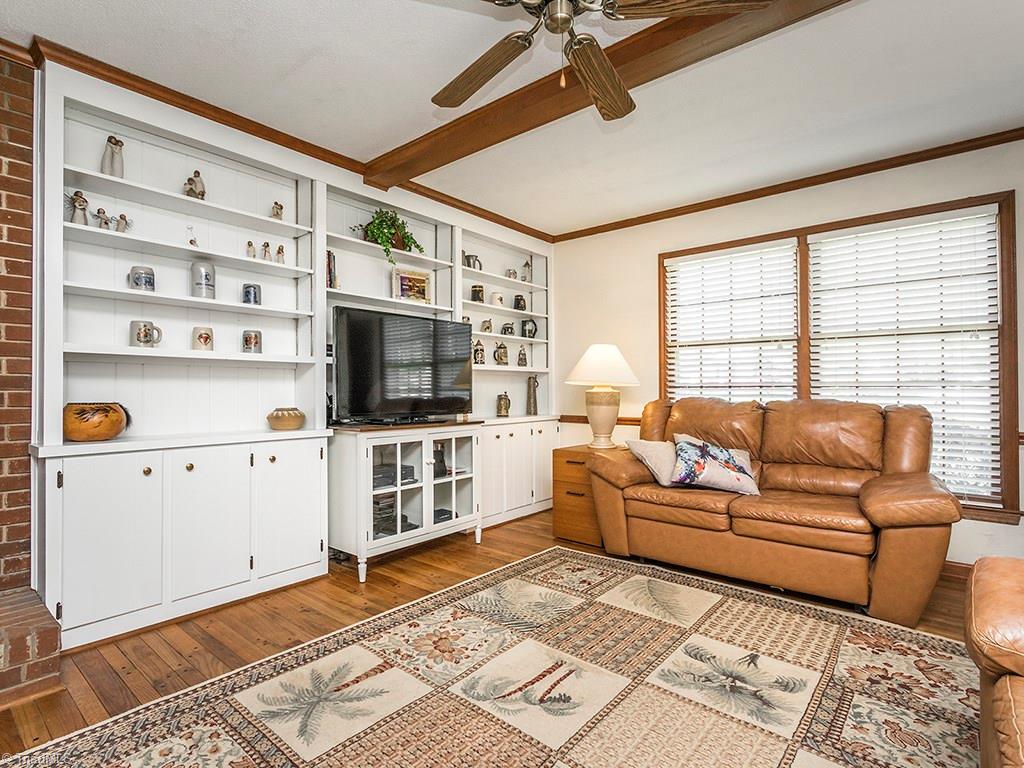 4521 Tower Road Greensboro, NC 27410 - Photo 13 of 28 The den also features ample built in cabinets. There is ample space to allow for a standing flat screen TV