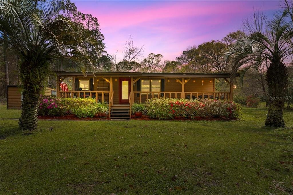 5300 Northwest 196th Way Starke, FL 32091 - Photo 1 of 1 a front view of a house with a garden
