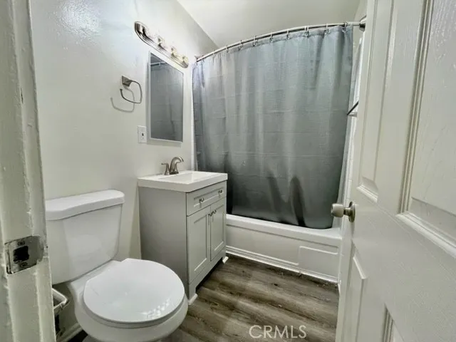 a bathroom with a sink a toilet a mirror and shower