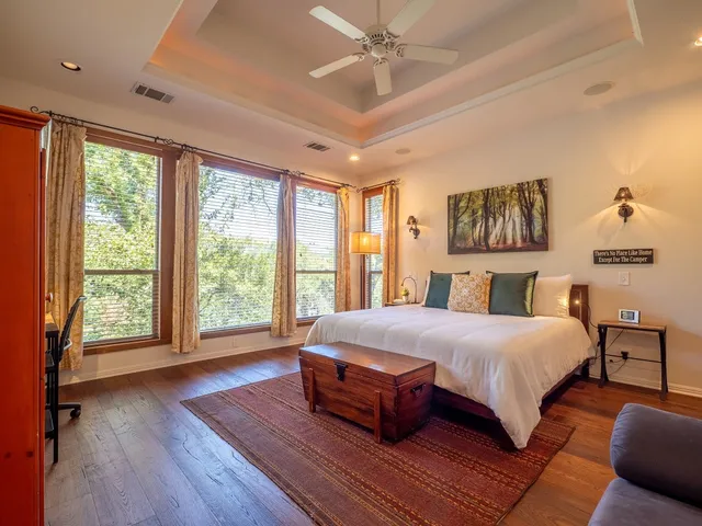 a bedroom with a large bed and a large window