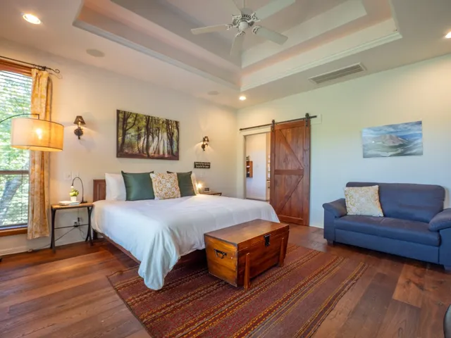 a spacious bedroom with a bed and a couch