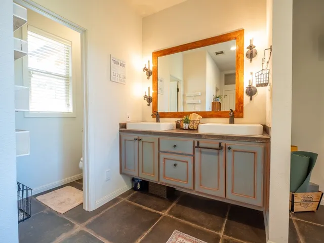 a bathroom with a double vanity sink and a mirror