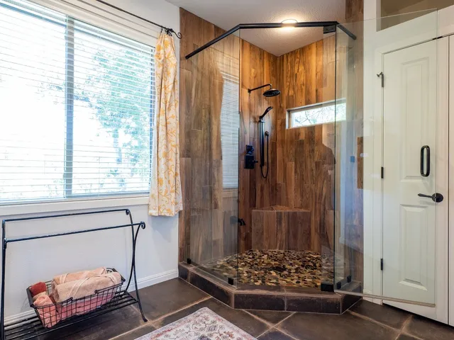 a bathroom with a mirror and a shower