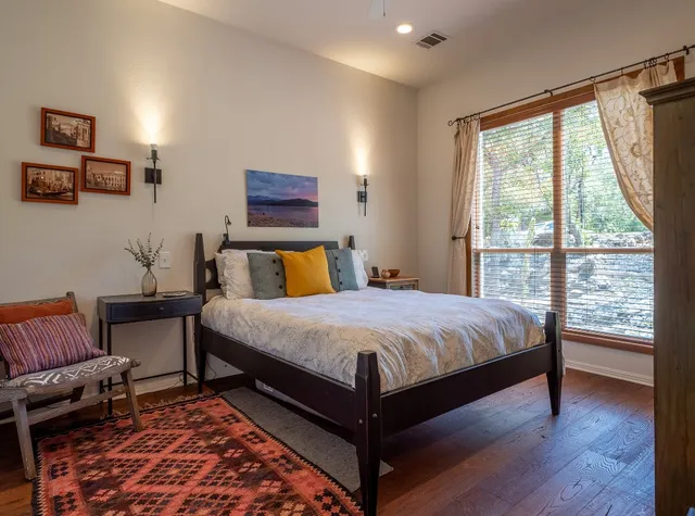 a bedroom with a large bed and a chair